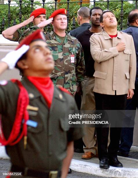 Venezuelan President Hugo Chavez , salutes the flag, along with members of the Venezuelan military at the Government Palace 11 December 2002. El...