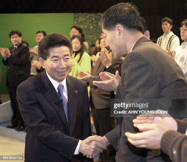 South Korean President-elect Roh Moo-hyun , is welcomed by audience at Korea Broadcasting System Center in Seoul prior to a television conference to...