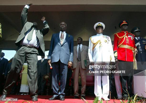 Bodyguard tries to catch objects thrown by the public to outgoing Kenyan president Daniel arap Moi before the swearing-in ceremony of newly elected...