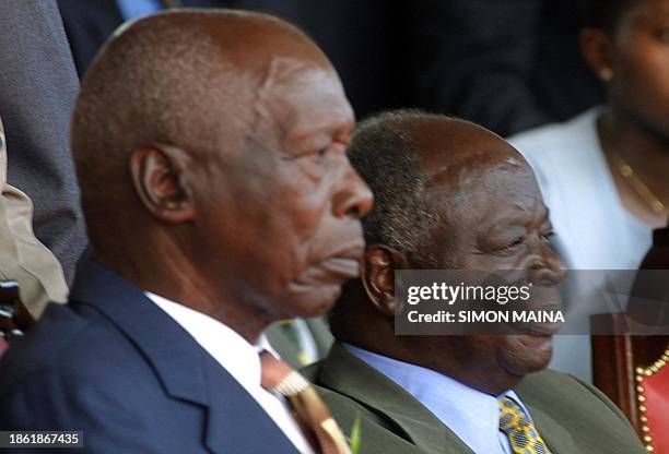 Outgoing Kenyan president Daniel arap Moi and newly elected Kenyan president, Mwai Kibaki, follow the proceedings of the swearing-in ceremony in...