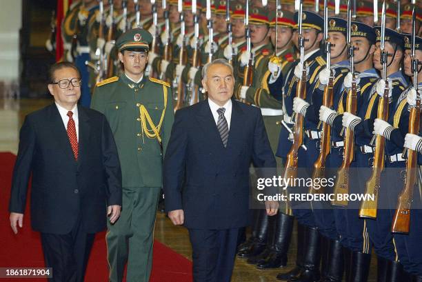 Visiting Kazakhstan President Nursultan Nazarbayev walks with Chinese President Jiang Zemin during a welcoming ceremony at the Great Hall of the...