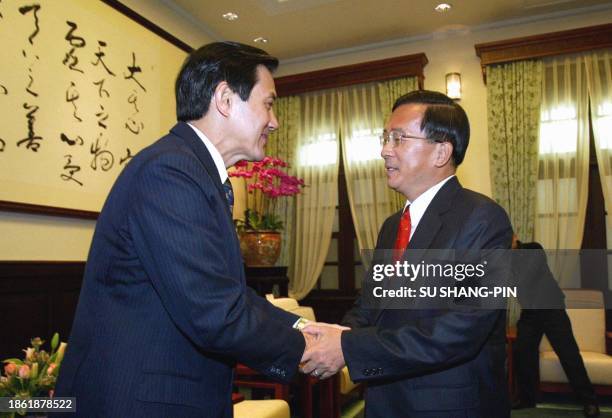 Ma Ying-jeou , newly elected mayor of Taipei from the main opposition Kuomintang party, is greeted by Taiwanese President Chen Shui-bian at the...