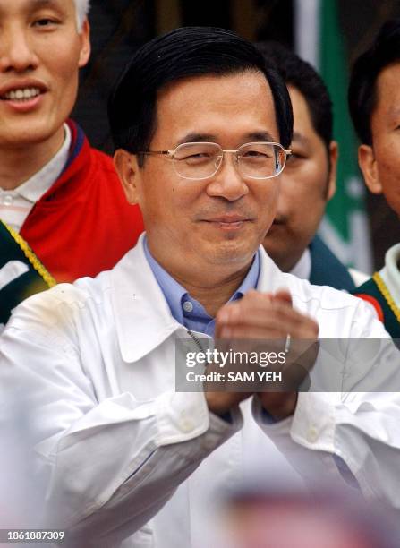 Taiwanese President Chen Shui-bian shakes his hands wishing for support from his party, the ruling Democratic Progressive Party , during a Taipei...