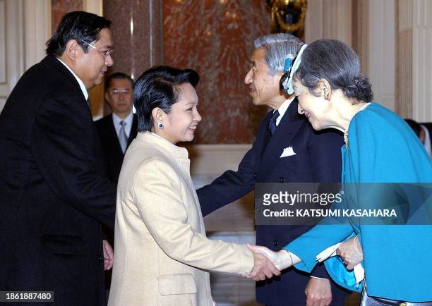 Philippine President Gloria Macapagal Arroyo is greeted by Japanese Empress Michiko as her husband Jose Miguel Arroyo is welcomed by Emperor Akihito...