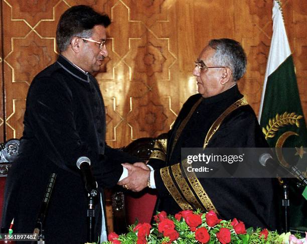 Pakistani President Pervez Musharraf shakes hands with Chief Justice Riaz Sheikh after taking oath as the country's ninth president during a ceremony...