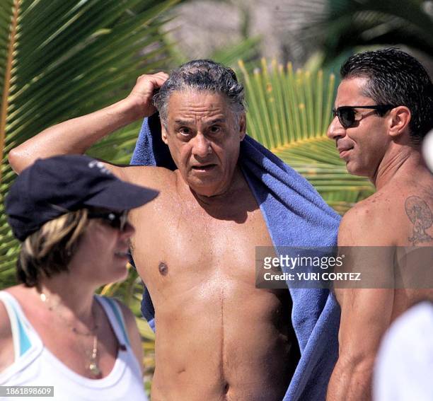 The president of Brazil Fernando Henrique Cardoso dries himself with a towel after taking a bath in the beach of the Barcelo tourist resort in Punta...