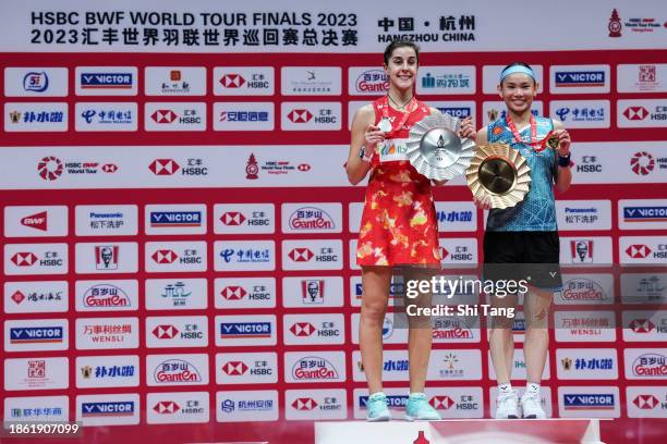 Tai Tzu Ying of Chinese Taipei and Carolina Marin of Spain pose with their trophies on the podium after the Women's Single Final match during day...