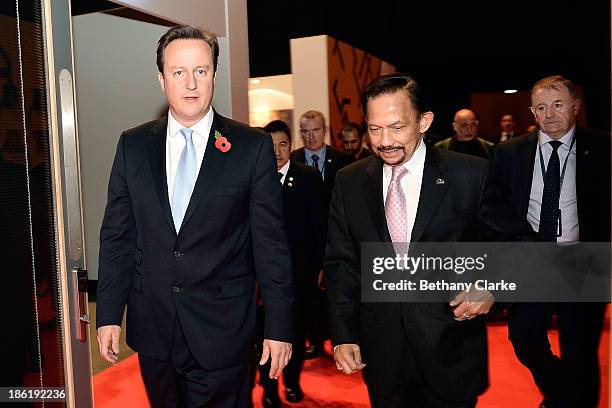 British Prime Minister David Cameron and H.M. Sultan Hassanal Bolkiah of Brunei Darussalam leave the main hall for lunch during the Leaders Panel at...