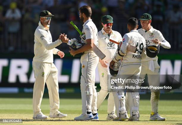 Nathan Lyon shakes hands with Shaheen Shah Afridi after Australia won the Men's First Test match between Australia and Pakistan at Optus Stadium on...