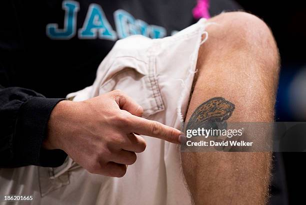 An excited Jacksonville Jaguars fan shows Jaguars and Fulham FC owner, Shahid Khan, a tattoo of the team logo prior to Sunday's football game between...