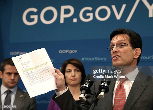 House Majority Leader Eric Cantor, holds a letter from a constituent while speaking to the media after attending the weekly House Republican...