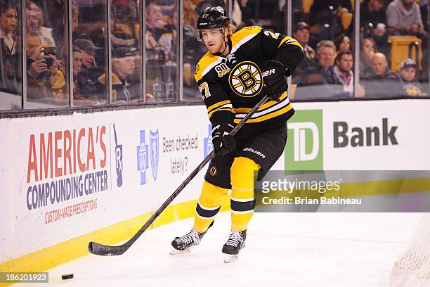 Dougie Hamilton of the Boston Bruins skates with the puck against the New Jersey Devils at the TD Garden on October 26, 2013 in Boston, Massachusetts.