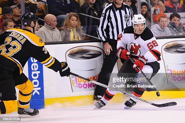 Jaromir Jagr of the New Jersey Devils tries to handle the puck against Zdeno Chara of the Boston Bruins at the TD Garden on October 26, 2013 in...