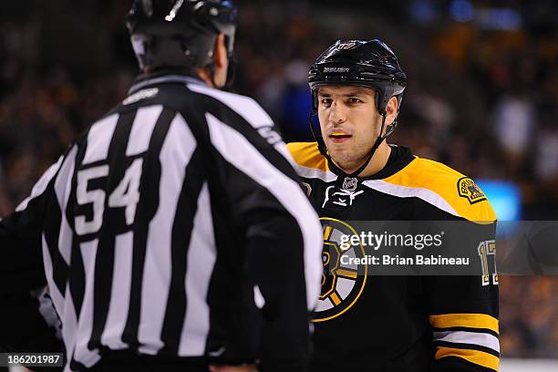 Milan Lucic of the Boston Bruins speaks with a linesman during a time out against the New Jersey Devils at the TD Garden on October 26, 2013 in...