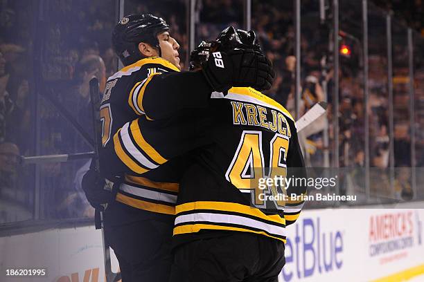 Milan Lucic and David Krejci of the Boston Bruins celebrate a goal against the New Jersey Devils at the TD Garden on October 26, 2013 in Boston,...