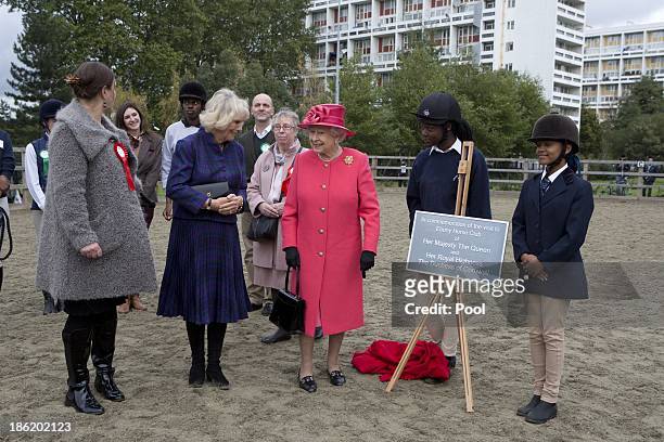 Queen Elizabeth II and Camilla, Duchess Of Cornwall are given a tour by Miss Ros Spearing, Director of Ebony Horse Club & Community Riding Centre,...