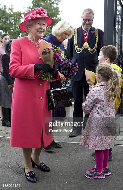 Queen Elizabeth II and Camilla, Duchess of Cornwall during a visit to Ebony Horse Club & Community Riding Centre on October 29, 2013 in London,...