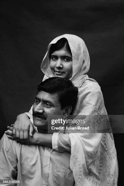 Education activist Malala Yousafzai is photographed with her father Ziauddin Malala for People magazine on August 30, 2013 in Birmingham, England.