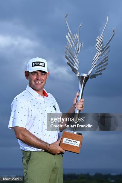 Louis Oosthuizen of South Africa poses with the trophy after victory on Day Four of the AfrAsia Bank Mauritius Open 2024 at Heritage La Reserve Golf...