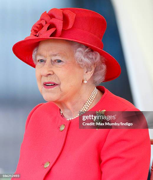 Queen Elizabeth II watches a riding display as she and Camilla, Duchess of Cornwall visit the Ebony Horse Club and Community Riding Centre on October...