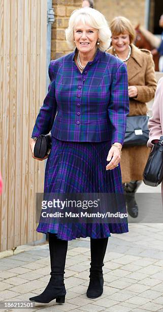 Camilla, Duchess of Cornwall accompanies Queen Elizabeth II on a visit to the Ebony Horse Club and Community Riding Centre on October 29, 2013 in...