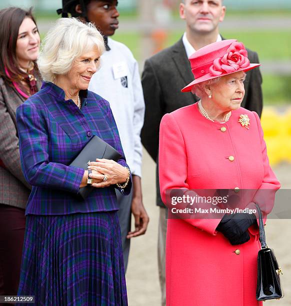 Camilla, Duchess of Cornwall and Queen Elizabeth II visit the Ebony Horse Club and Community Riding Centre on October 29, 2013 in London, England.