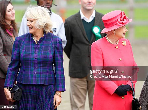 Camilla, Duchess of Cornwall and Queen Elizabeth II visit the Ebony Horse Club and Community Riding Centre on October 29, 2013 in London, England.
