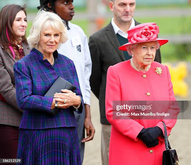 Camilla, Duchess of Cornwall and Queen Elizabeth II visit the Ebony Horse Club and Community Riding Centre on October 29, 2013 in London, England.