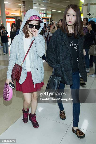 Sunny and Yoona of South Korean girl group Girls' Generation are seen upon arrival at the Gimpo Airport on October 28, 2013 in Seoul, South Korea.