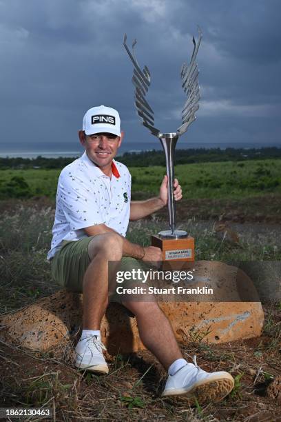 Louis Oosthuizen of South Africa poses with the trophy after victory on Day Four of the AfrAsia Bank Mauritius Open 2024 at Heritage La Reserve Golf...
