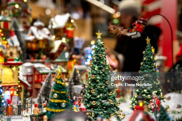 toy christmas tree with lights in snow outside in toy town. new year christmas card - tradition town square stock pictures, royalty-free photos & images