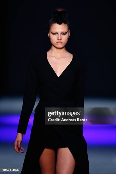 Model walks the runway at The Muscovites By Masha Kravtsova show during Mercedes-Benz Fashion Week Russia S/S 2014 on October 29, 2013 in Moscow,...