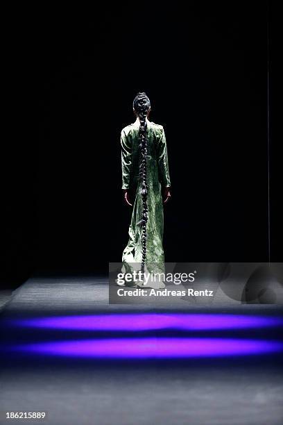 Model walks the runway at The Muscovites By Masha Kravtsova show during Mercedes-Benz Fashion Week Russia S/S 2014 on October 29, 2013 in Moscow,...