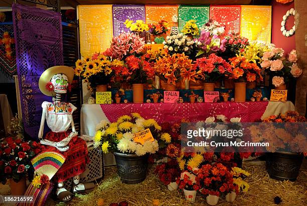 The flower vendor at the "The Aroma of Life" display at the Mexican Cultural Center's Día de Muertos exhibit on Monday, October 21, 2013. The exhibit...
