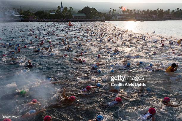 Triathletes start the 2.4 mile swim portion of the Ironman World Championships on October 12, 2013 in Kailua Bay, Hawaii.