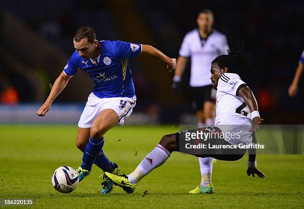 Daniel Drinkwater of Leicester City is tackled by Derek Boateng of Fulham during the Capital One Cup fourth round match between Leicester City and...