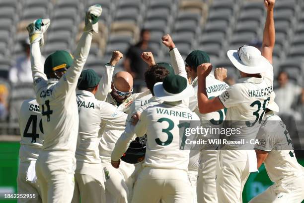 Nathan Lyon of Australia celebrates after taking five hundred test wickets during day four of the Men's First Test match between Australia and...