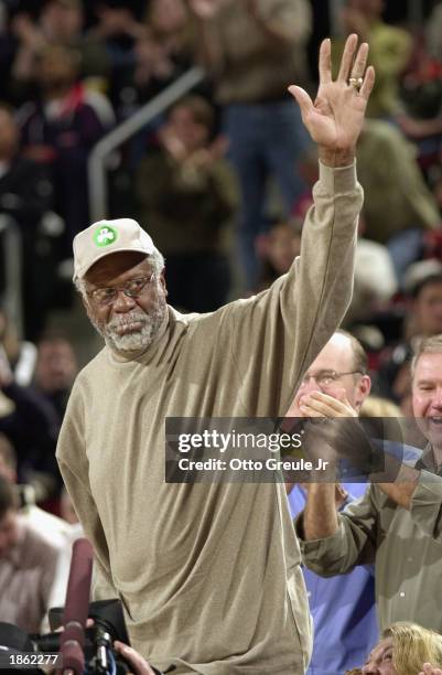 Former Celtic great Bill Russell waves during the game between the Boston Celtics and the Seattle Sonics at Key Arena on February 11, 2003 in...