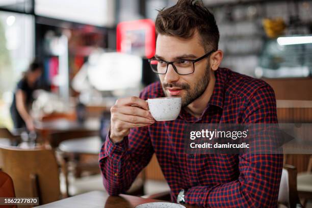 young atractive man drinking coffee at a cafe - portrait atractive man stockfoto's en -beelden