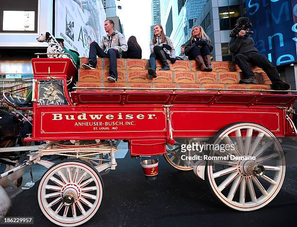 Olympic athletes Billy Demong, Heather McPhie and Gretchen Bleiler ride through Times Square with the Budweiser Clydesdales during the USOC 100 Days...