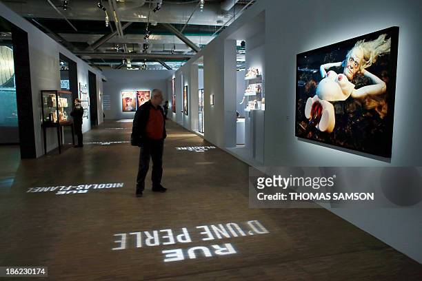 Man walks past an untitled work of art, from the Sex Pictures Series by US artist Cindy Sherman, displayed during the exhibition Le surrealisme et...