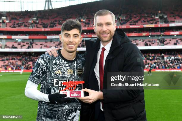 Kai Havertz is presented the Player Of The Month award by former player Per Mertesacker during the Premier League match between Arsenal FC and...