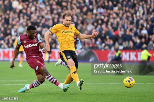 Mohammed Kudus of West Ham United scores their team's second goal whilst under pressure from Craig Dawson of Wolverhampton Wanderers during the...