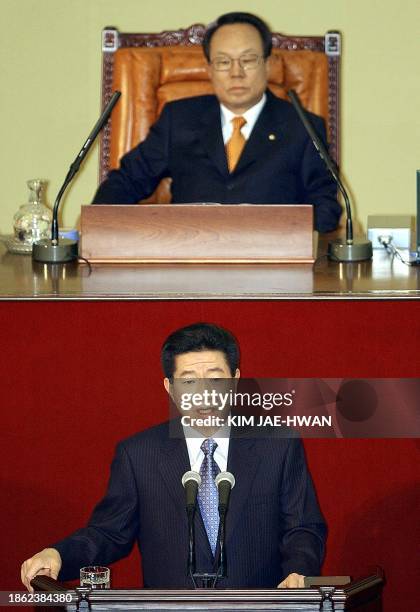 National Assembly Chairman Park Kwan-Yong listens to South Korean President Roh Moo-Hyun delivering his speech to the National Assembly to endorse...