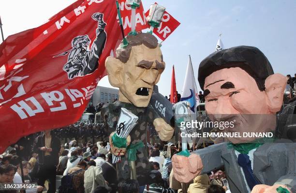 Effigies of US President George W. Bush and his South Korean counterpart, Roh Moo-Hyun, are paraded by South Korean activists, 02 April 2003, during...