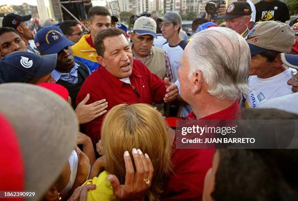 Venezuelan President Hugo Chavez speals to Vice President Jose Vicente Rangel , 23 January in Caracas, on the 53rd day of a general strike demanding...