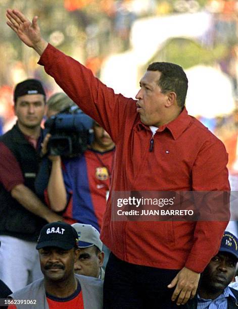 Venezuelan President Hugo Chavez greets pro-government marchers 23 January in Caracas, on the 53rd day of a general strike demanding his resignation....