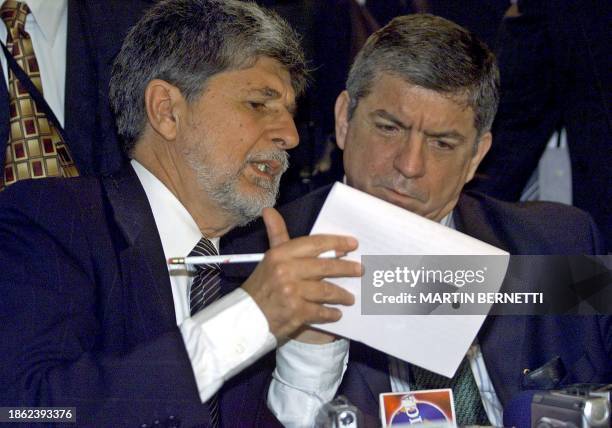 The President of the Organizations of American States , Cesar Gaviria , discusses a document with Brazilian chancellor Celso Amorim, during a press...