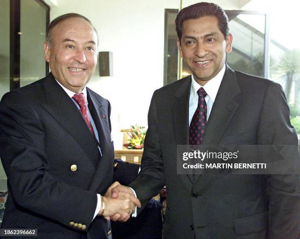 President elect Lucio Gutierrez , greets the President of the Corporacion Andina de Fomento , Enrique Garcia, during a private meeting in Quito, 14...