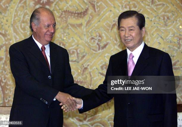 South Korean President Kim Dae-jung greets his Chilean counterpart Ricardo Lagos at the presidential Blue House in Seoul, 15 February 2003. The two...